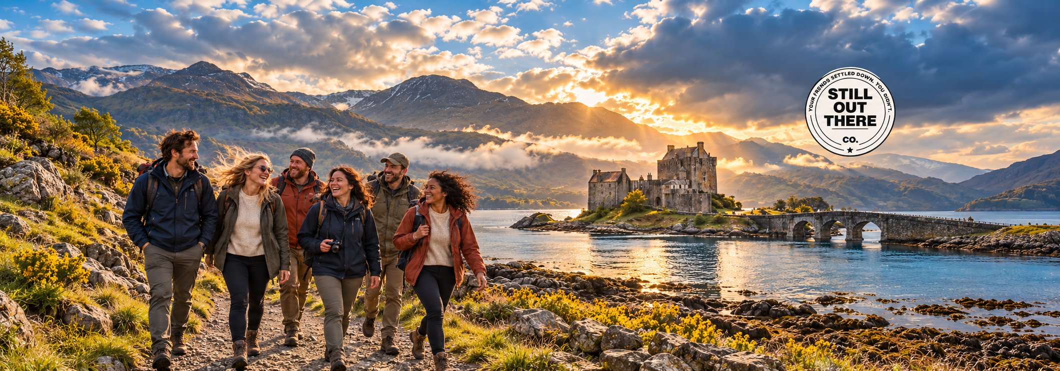 Still Out There Scotland cover artwork: a group of travelers beside Eilean Donan Castle and its stone bridge in the Highlands